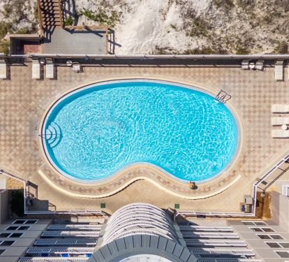 You'll be right on the beach as you step past the heated pool and hot tub