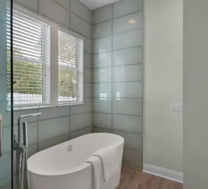 Aqua-14 unwind with a glass of wine in the freestanding master tub.
