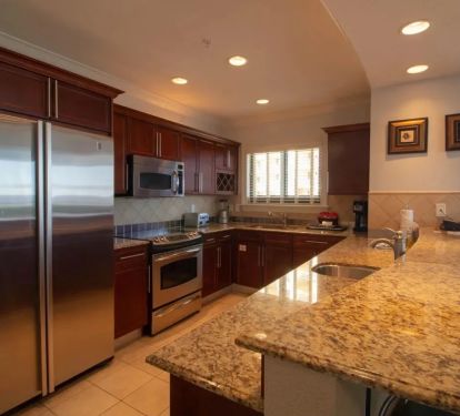 Large kitchen with all the appliances, and breakfast counter seating.