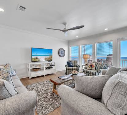 Comfortable, tastefully decorated living area with flat screen tv and beach view.