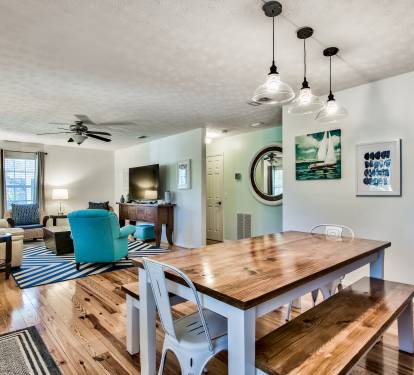 Open concept living and dining, complete with a large, farmhouse-style table.