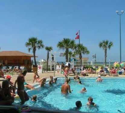 ocean front large pools with beach chairs and umbrella