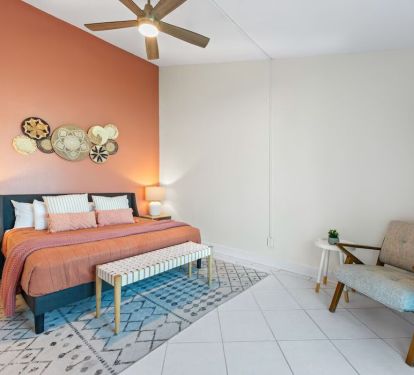 This spacious en suite bedroom features warm coastal tones, cozy textures, and a private bathroom&mdash;perfect for guests who prefer no stairs and easy access to everything.