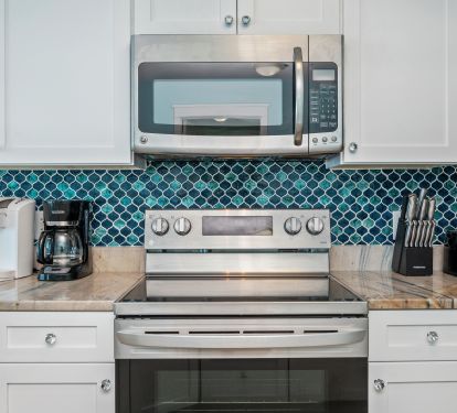 Classy kitchen with stainless appliances and new tile accents