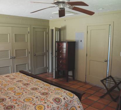 Bedroom view facing the bathroom and closet. Washer and dryer in right closet