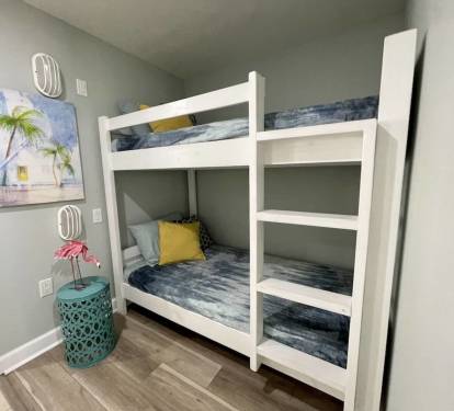 Twin bunk beds located in hallway alcove.