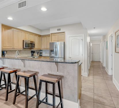 Spacious kitchen with granite counters and large breakfast bar.