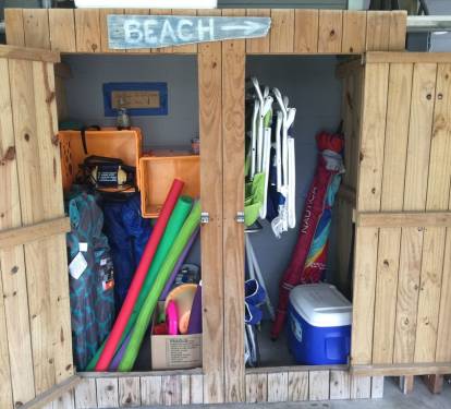 Beach locker with chairs, umbrella, cart, cooler for your use