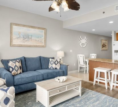 Coastal-inspired living space with a plush blue sofa, accent chair.