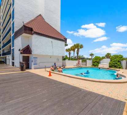 POOL LOCATED BETWEEN BUILDING IN BREEZWAY WITH OCEAN VIEWS
