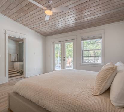 Primary Suite 1 w/ remodeled ensuite bath &amp; private deck w/ chairs and loungers