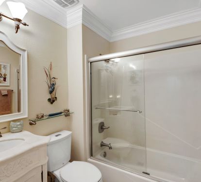 Hall bathroom (next to 3rd bedroom) with bathtub and frameless shower doors