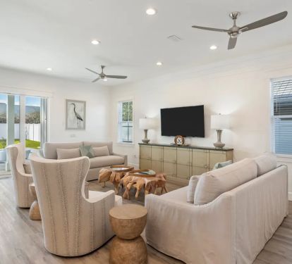 Ovation-7 first-floor living room offers a blend of coastal style and comfort in its seating arrangements. (Note: The 2nd floor also features its own living space, providing multiple options for your group's comfort and convenience.)
