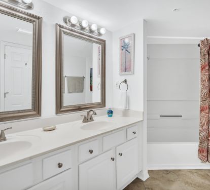 Private master bathroom with double sinks and shower tub.