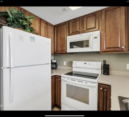 Fully equipped coastal kitchen with breakfast bar and open living space