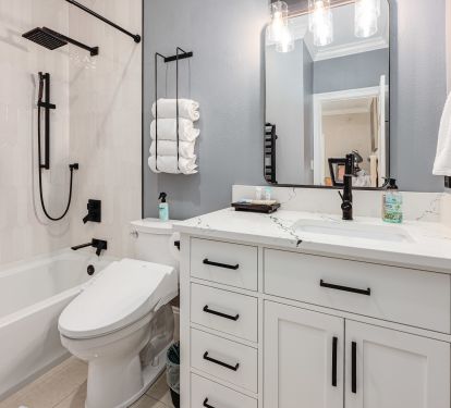 Well-appointed bathroom featuring a soaking tub, heated towel rack, and TOTO Washlet for a refined, spa-like touch.
