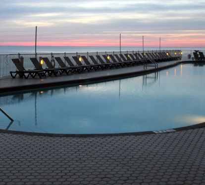 Our 120 ft long heated pool on the beach and Gulf of Mexico at sunset