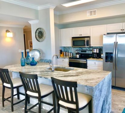 Over-sized breakfast bar in fully stocked kitchen...