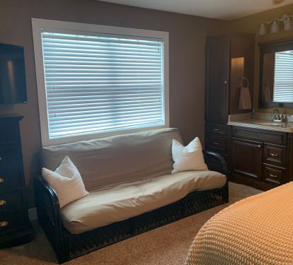 futon and vanity in master bedroom