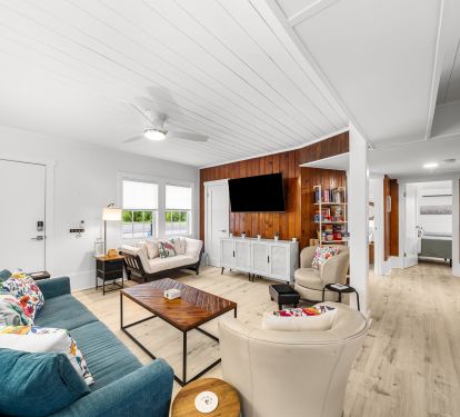 View of the den and hall leading to a king room, twin room &amp; hall bathroom.