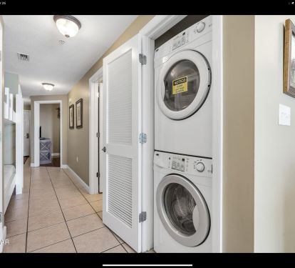 Hallway with bunk beds, in-unit washer dryer, and easy kitchen access