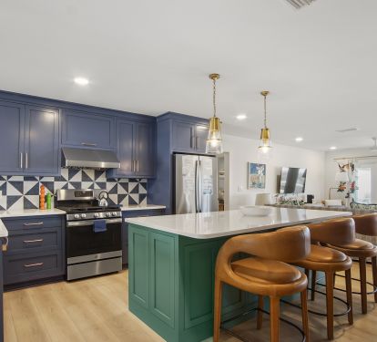 Kitchen with 3 barstools and bar dining area