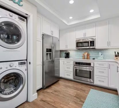 Top-of-the-line stainless steel appliances, custom cabinetry, crisp quartz countertops