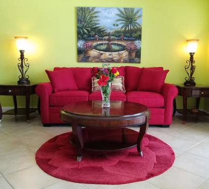 Large living area with 65" TV and Queen sofa bed