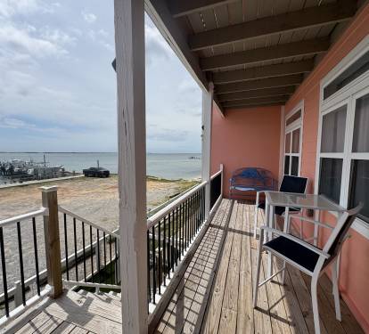 Balcony with patio furniture overlooking the water and marina