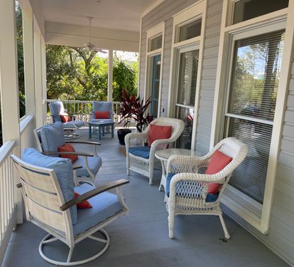 Expansive front porch accommodates up to 16 people, dining/shuffle board table