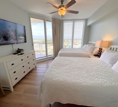 Bdrm 2-  Two queen size beds, city balcony access, ultra 4k 55 inch Roku TV.