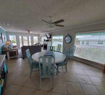 Round dining table allows seating for up to 8 when you add the 2 desk chairs.