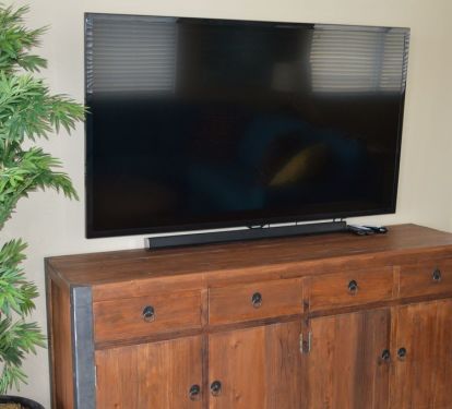 Huge 65 inch Samsung TV. An HDMI cable is provided for connecting a laptop