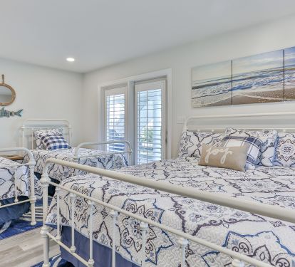 1st floor bedroom with twin over dbl bunk, 2 twins, one king bed. Door to pool.