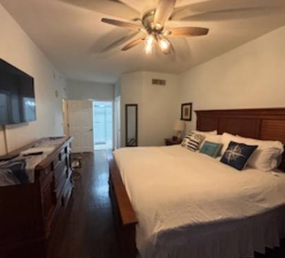 Spacious Master Bedroom with big flat screen TV.