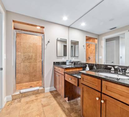 Large master bath with double sinks, walk-in travertine shower and toilet room
