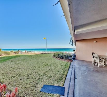 Patio and greenspace that leads to the beach walkover