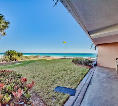 Patio and greenspace that leads to the beach walkover