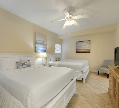 This spacious guest bedroom at Crescent 110 offers two comfortable beds, making it perfect for families enjoying a beachfront vacation in Destin.