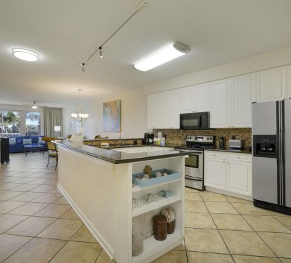 Granite countertops, stainless appliances, and thoughtful coastal details create a welcoming space that feels like your home by the sea.
