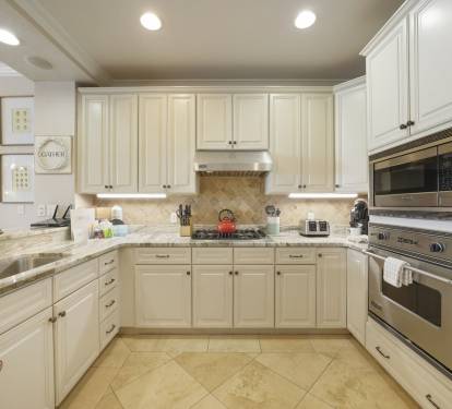 Views of the SPACIOUS with granite countertops and an adjacent dining room