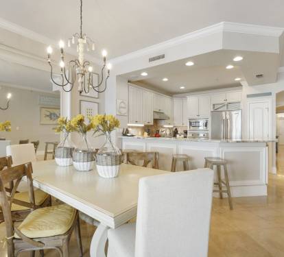 The whole family can dine after preparing delicious meals in the bright open concept kitchen and dining room with white cabinetry and modern finishes