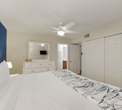 Wake up refreshed in a stylish master bedroom with soft neutral tones, elegant lighting, and a relaxing beach house atmosphere.
