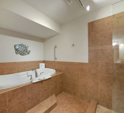 Large shared soaker tub and shower room designed for convenience, offering both relaxation and functionality in Cabana Club 205