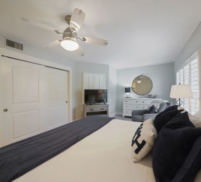 Enjoy restful nights in this bright coastal bedroom complete with elegant furnishings and soft, soothing tones.