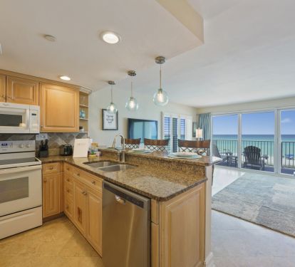 Prepare family meals in the stylish kitchen of this Gulf front condo just steps from Destin-s white sand beaches.