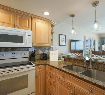 Cook with a view in this Destin beachfront condo featuring a fully equipped kitchen and Gulf-facing breakfast bar.