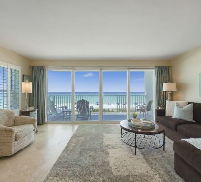 The bright and airy living space features elegant furnishings and stunning waterfront views along the Emerald Coast.