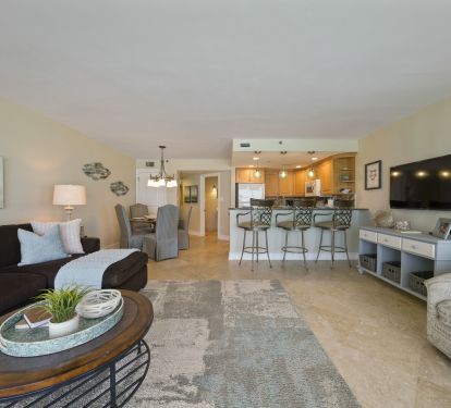 Enjoy spacious coastal living with a modern kitchen, breakfast bar seating, and comfortable furnishings in this Gulf front vacation rental.