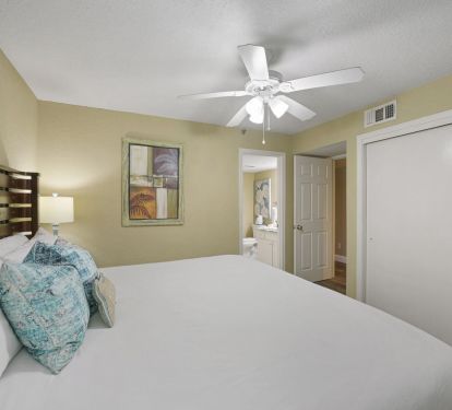 Relaxing master suite with king bed, wood furnishings, and bright natural light for a serene stay.